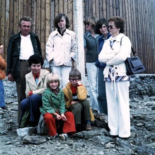 Family group photo outdoors in 1970s attire.