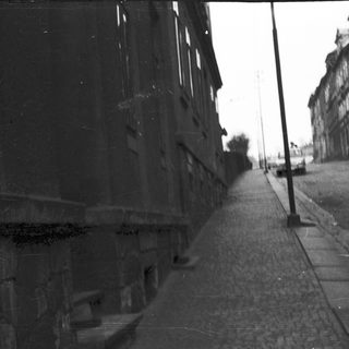 Narrow alleyway with two children walking.