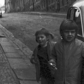Narrow alleyway with two children walking.