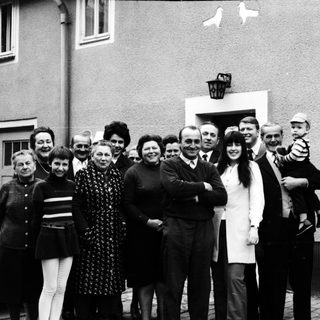 Family group photo outside residential building.