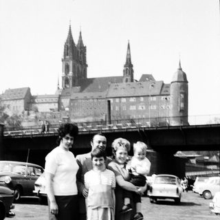 Family photo near historic cathedral with spires.