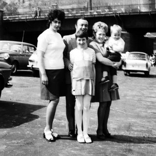 Family photo near historic cathedral with spires.
