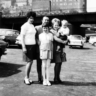 Family photo near historic cathedral with spires.
