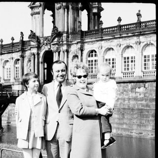 Family portrait in front of historic palace.