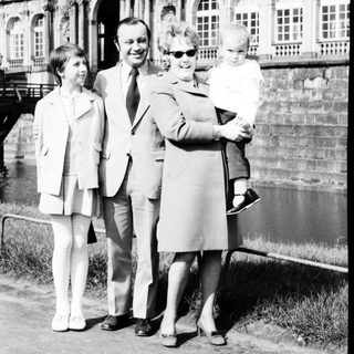 Family portrait in front of historic palace.