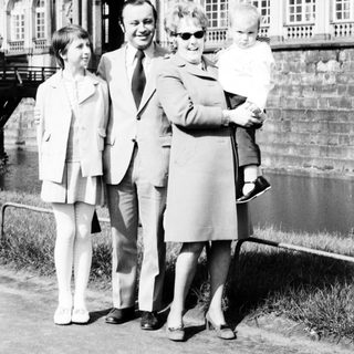 Family portrait in front of historic palace.