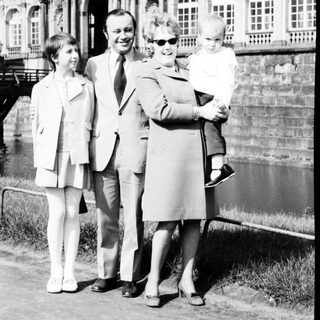 Family portrait in front of historic palace.