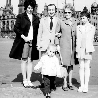 Family group photo in front of historic cityscape.
