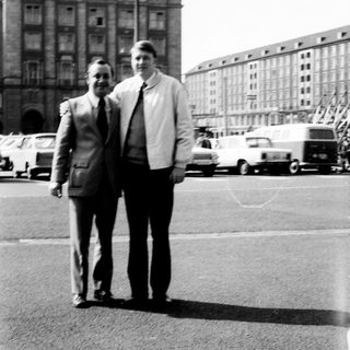 Two men posing in front of a building labeled "Centrum."