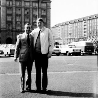 Two men posing in front of a building labeled "Centrum."