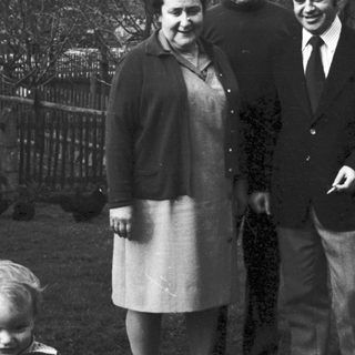 Family group photo outdoors in winter attire.