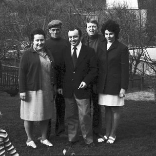 Family group photo outdoors in winter attire.