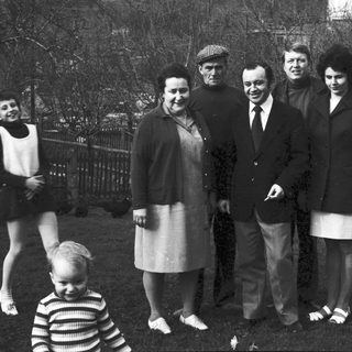 Family group photo outdoors in winter attire.