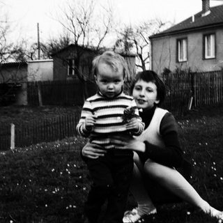 Two children playing outdoors in a backyard.