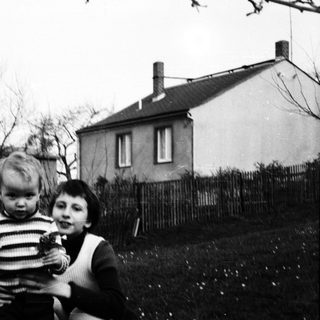 Two children playing outdoors in a backyard.