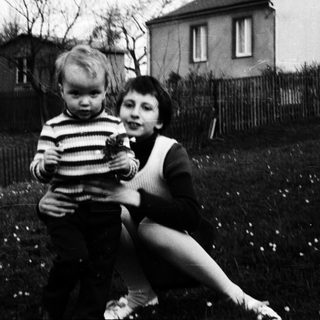 Two children playing outdoors in a backyard.