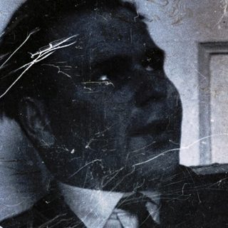 Man in suit with cracked, reflective surface.