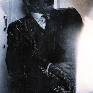 Man in suit with cracked, reflective surface.