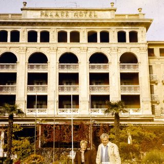 Elderly couple posing in front of Pera Palace Hotel.
