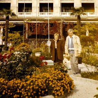 Elderly couple posing in front of Pera Palace Hotel.