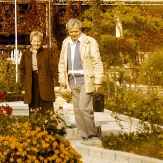 Elderly couple posing in front of Pera Palace Hotel.