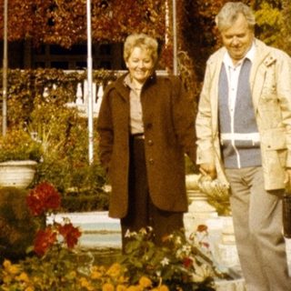 Elderly couple posing in front of Pera Palace Hotel.