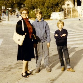 Family posing outside a large building.