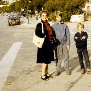 Family posing outside a large building.