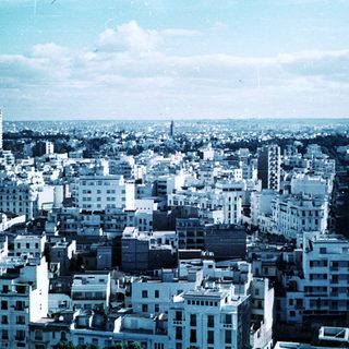 Urban cityscape with mid-rise buildings and wide avenue.