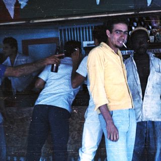 Group of men posing indoors at a bar.
