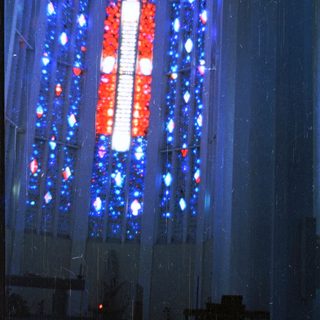 Stained glass window depicting religious figure.