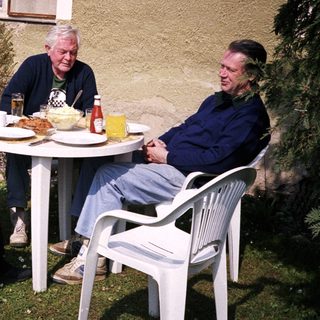 Four people enjoying outdoor meal together.