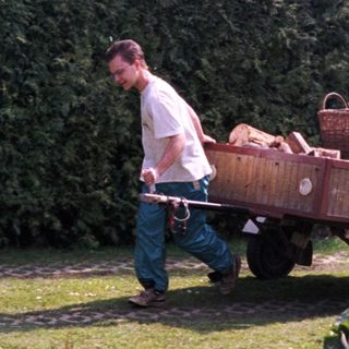 Two men harvesting and transporting vegetables.