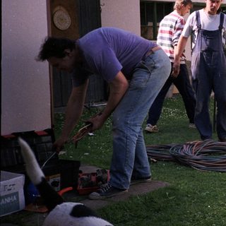 People connecting a camper to utilities.