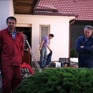 Men working on outdoor home renovation.