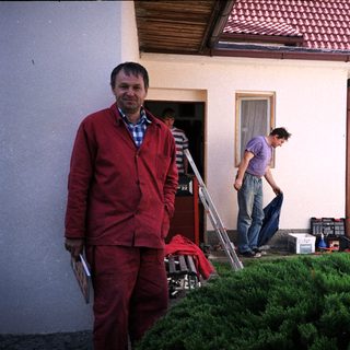 Men working on outdoor home renovation.