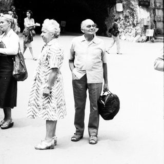 People exploring an indoor cave entrance.