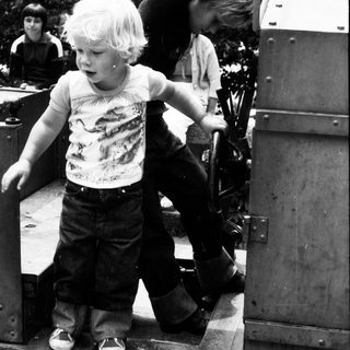 Children playing on old military vehicle.