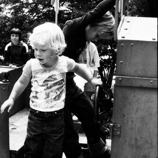 Children playing on old military vehicle.