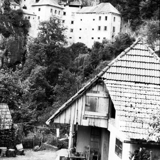 Historic castle perched on rocky cliffside.