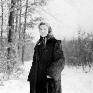 A person standing in a snowy forest.