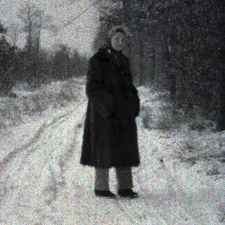 A solitary person walking alone on a snow-covered path.