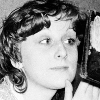 Woman using vintage portable radio.