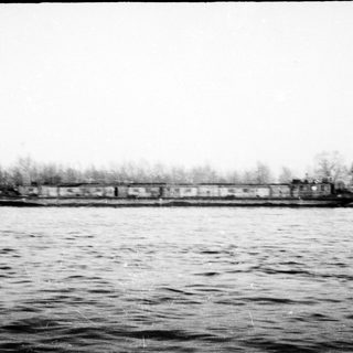 Train crossing a flooded or icy river.