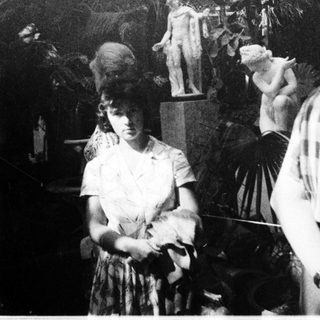 Vintage photo of woman in 1920s-style dress with feathered decor.