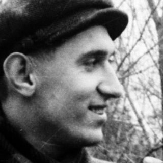 Two men in winter attire smiling outdoors.