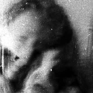 Blurred vintage photo of a person outdoors.