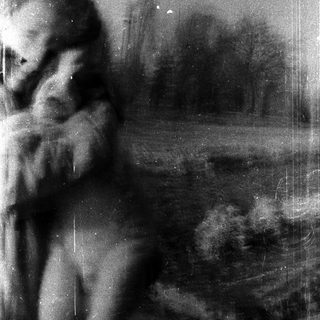 Blurred vintage photo of a person outdoors.