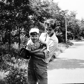 Two people walking on a rural road.
