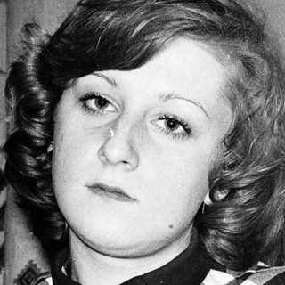 Young woman in checkered shirt, mid-20th century style.